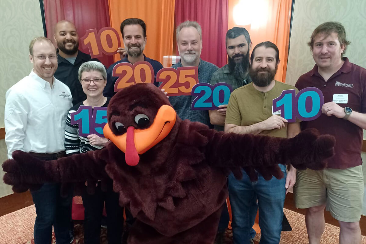 Andrew Krum, Mario Jones, Angie Parvin, Zac Doerzaph, Jared Bryson, Carl Cospel, Neal Feierabend, and Bill Freeman with the Hokie Bird