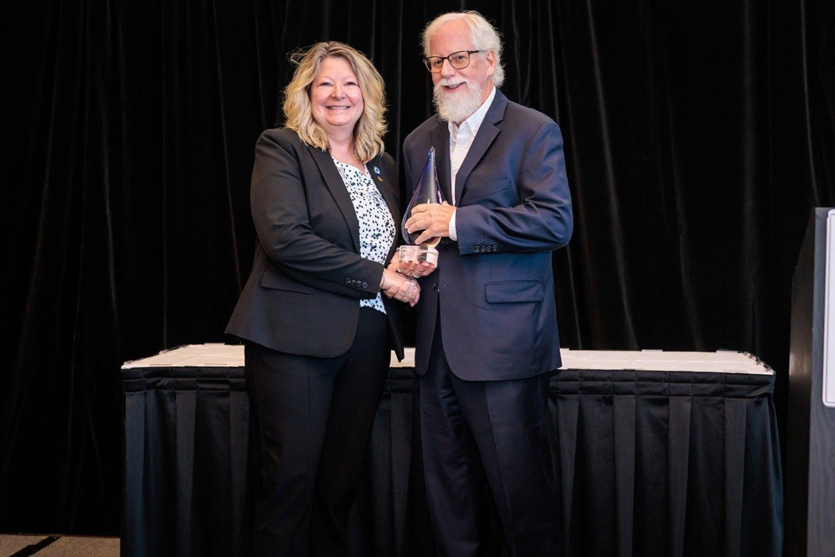 Tom Dingus (at right) accepts the James J. Howard Highway Safety Trailblazer Award from Lauren Steward, director of the Maine Bureau of Highway Safety. Photo courtesy of Chad Isaiah Photo.