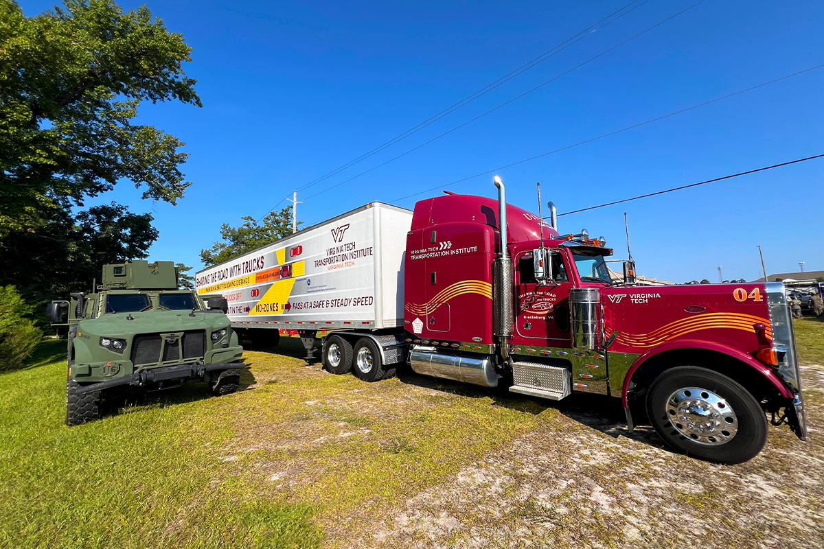 A joint light tactical vehicle in the blind spot of a semi-truck