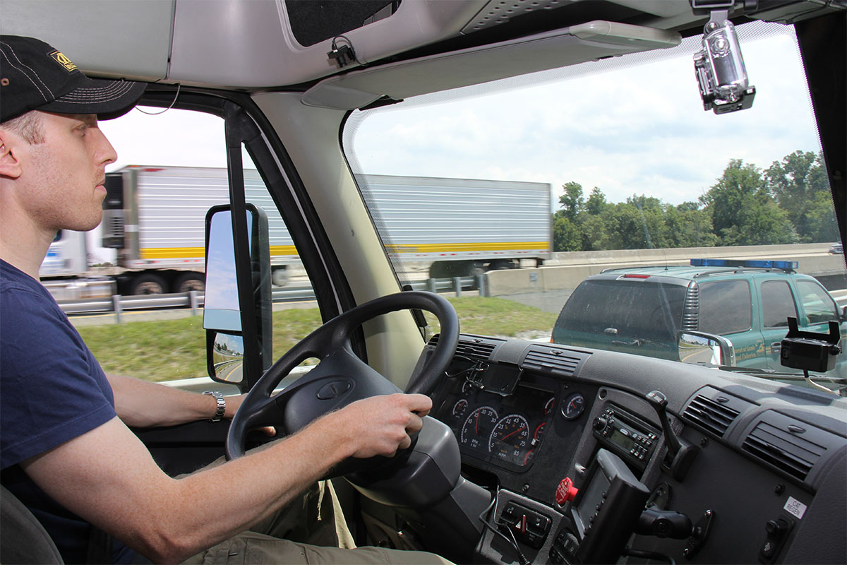 Male driver in cab of tractor trailer